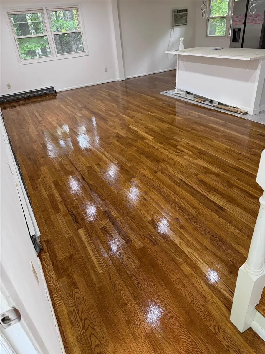 Refinished oak strip floor with a gloss finish in an open room
